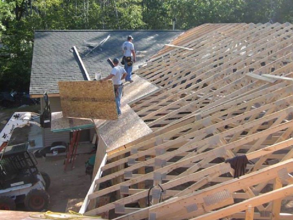 Adding a new roof on a house.